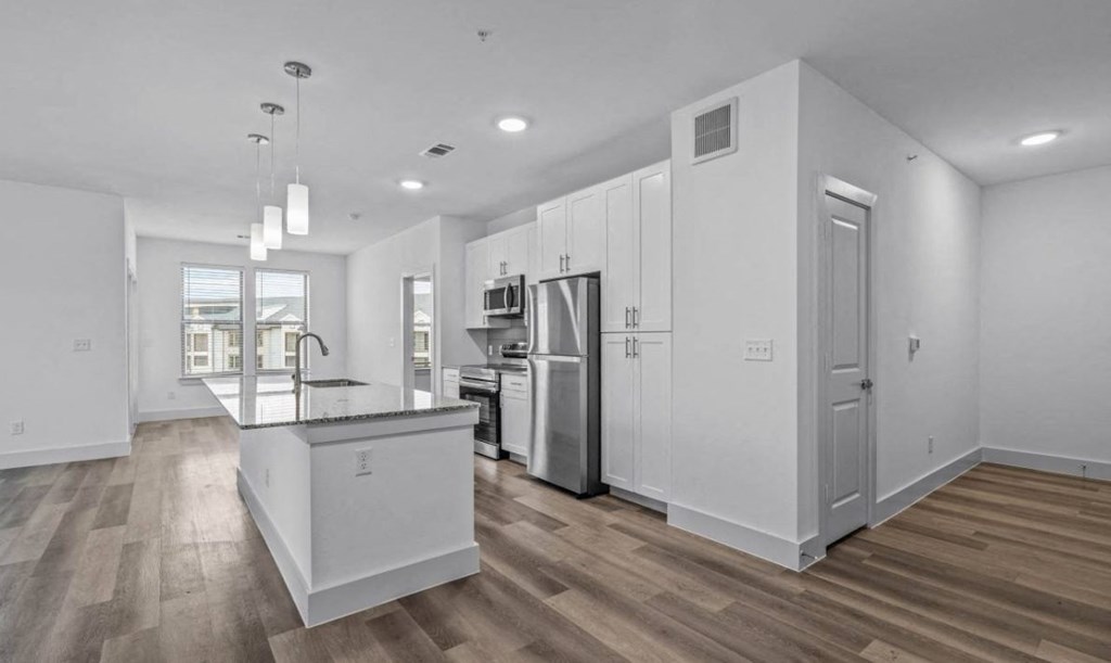 a room with a white wall and a wooden floor
