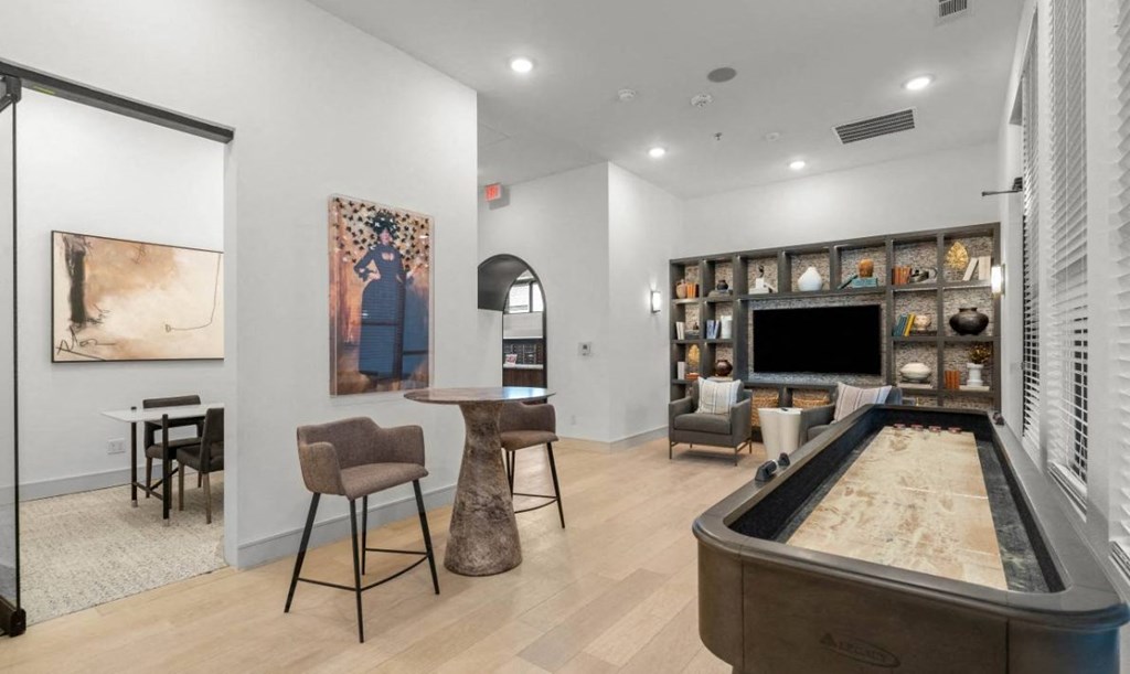 a game room with a pool table and a television