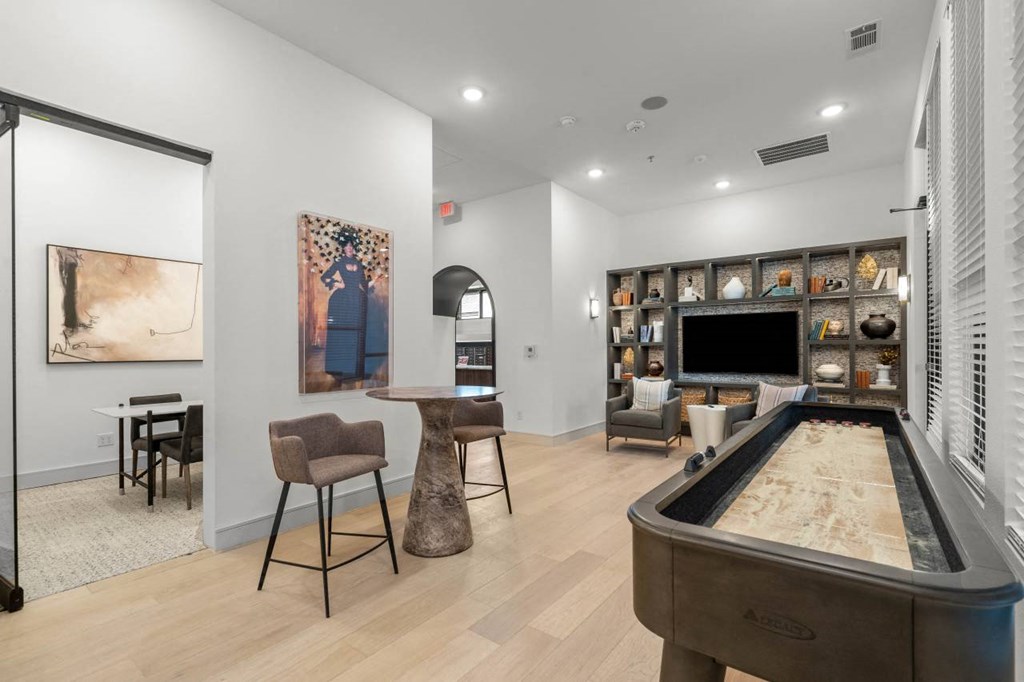 a living room with a pool table and a television