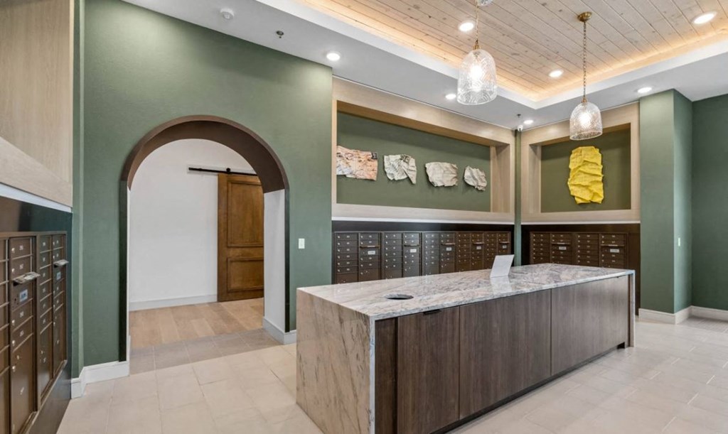 a large lobby with a reception desk and a door