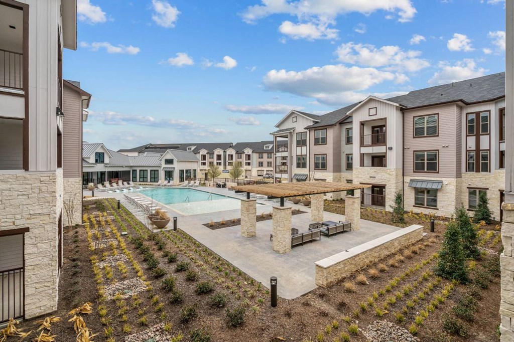 an apartment building with a pool and a courtyard