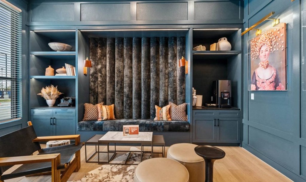 a living room with blue walls and a couch and blue cabinets