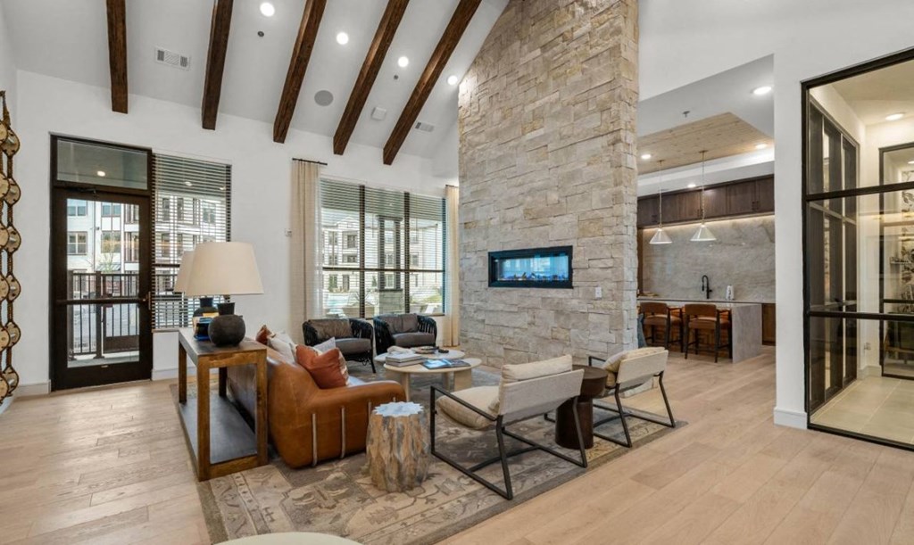 a large living room with a stone fireplace and a tv
