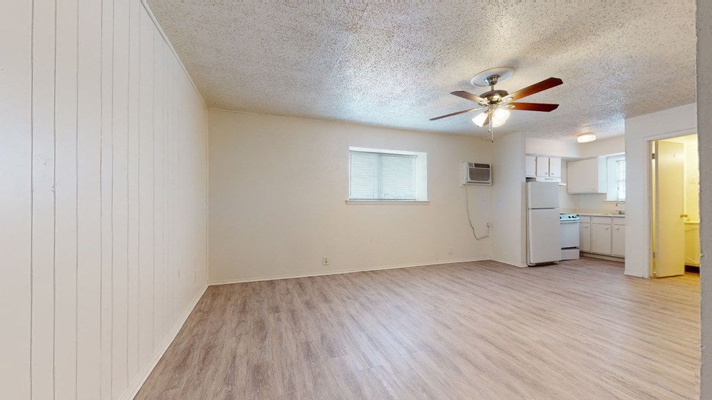 A room with a ceiling fan and a window.