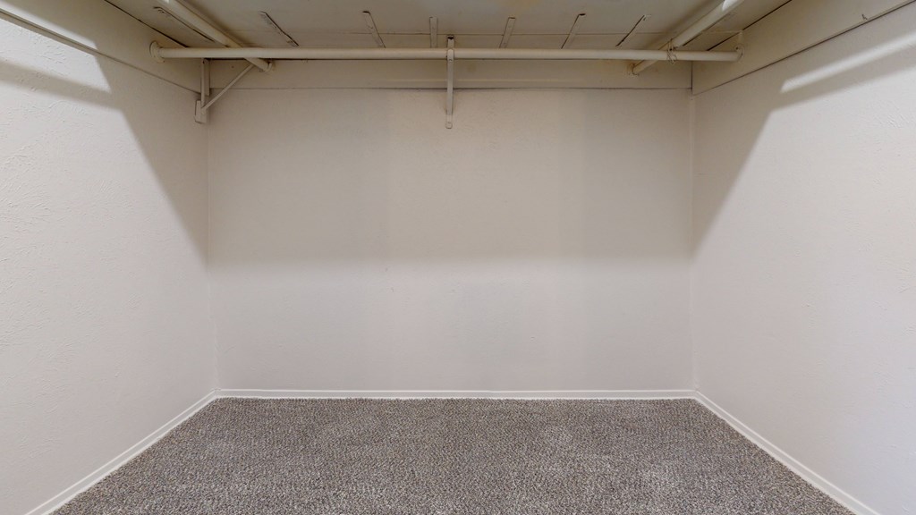 A room with a grey carpet and white walls.
