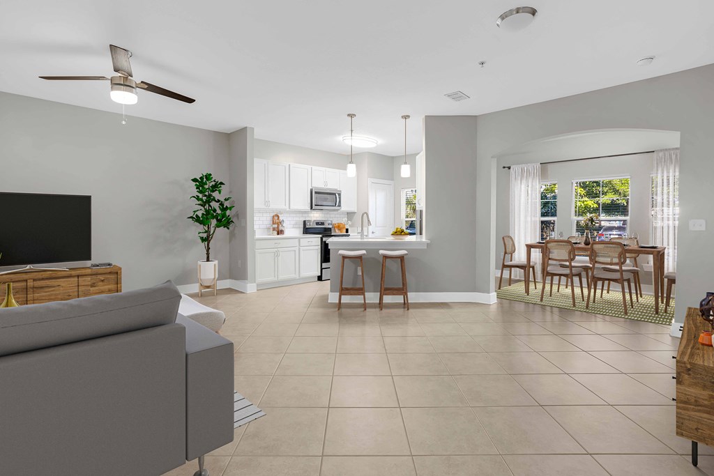 a living room with a couch and a table with chairs