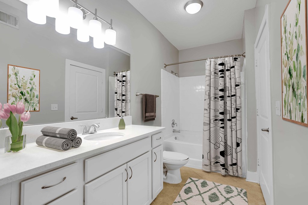 a bathroom with a white sink and a shower and a toilet