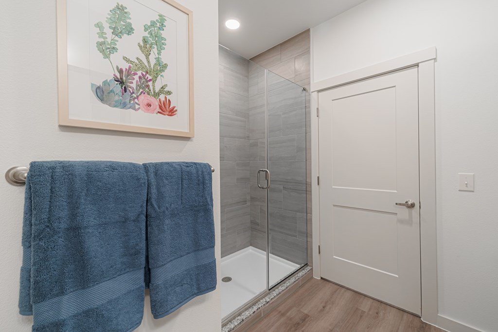 A bathroom with a blue towel hanging on the wall.