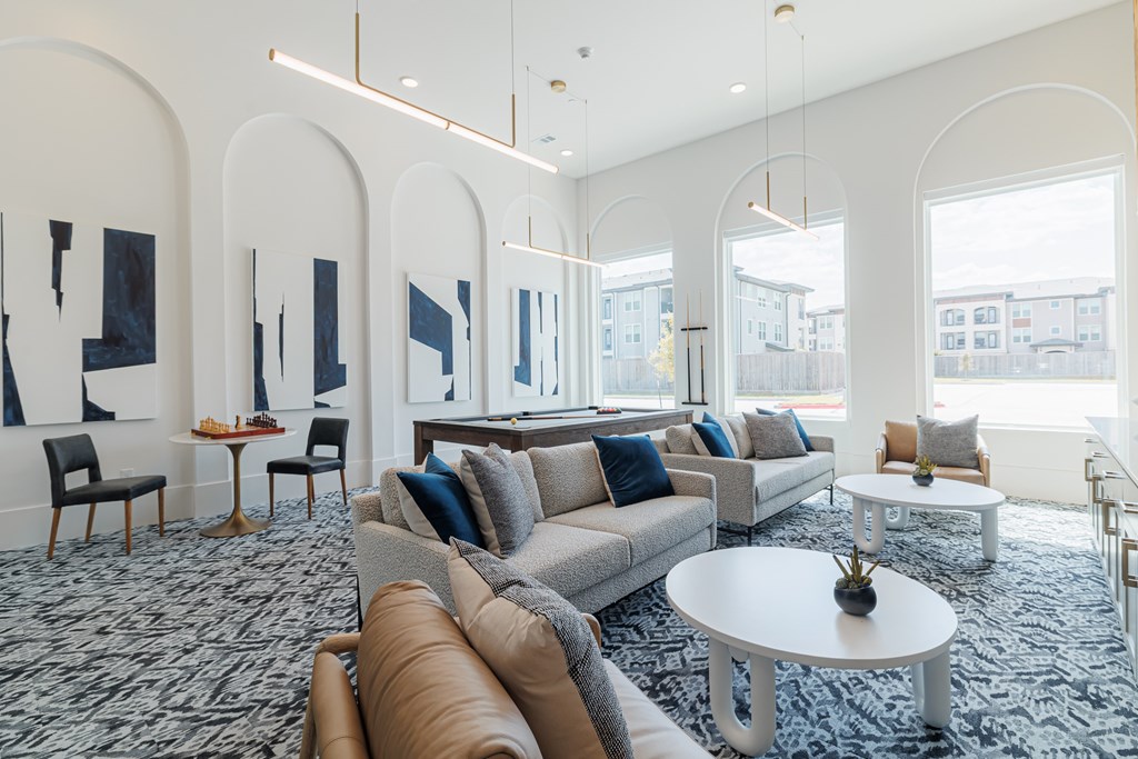 A living room with a grey sofa and a white coffee table.