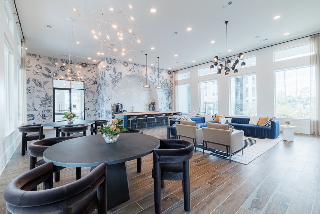 A modern living room with a round table and chairs.