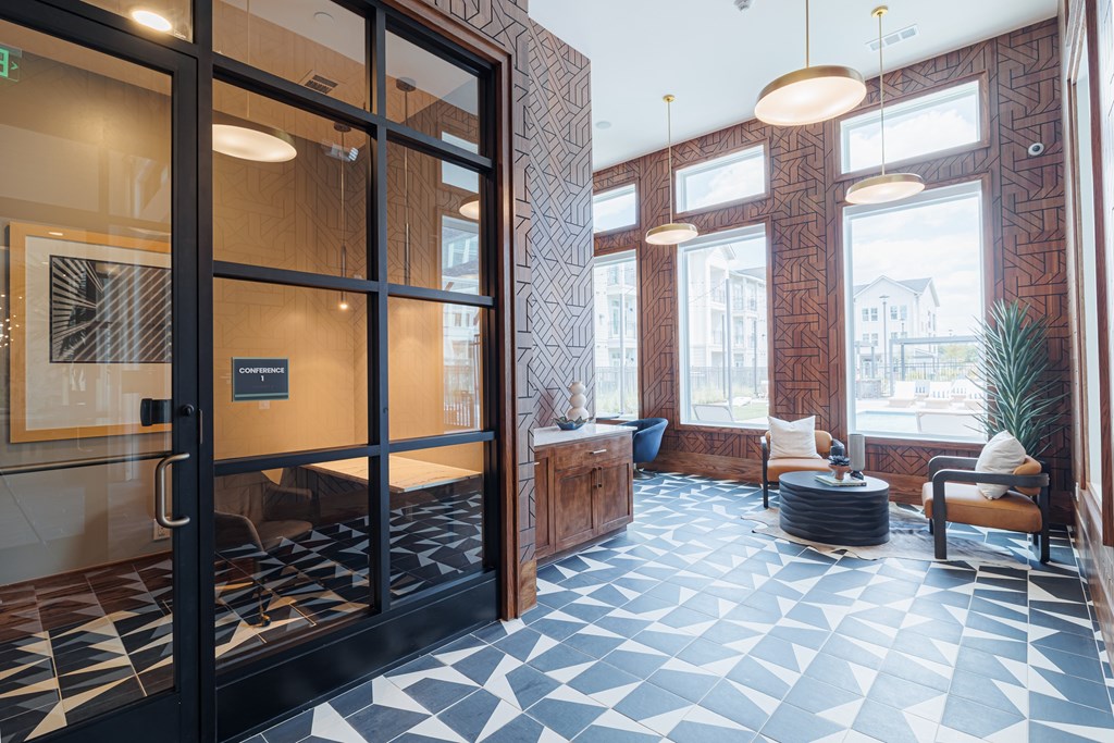A black and white tiled floor in a room with a glass door.