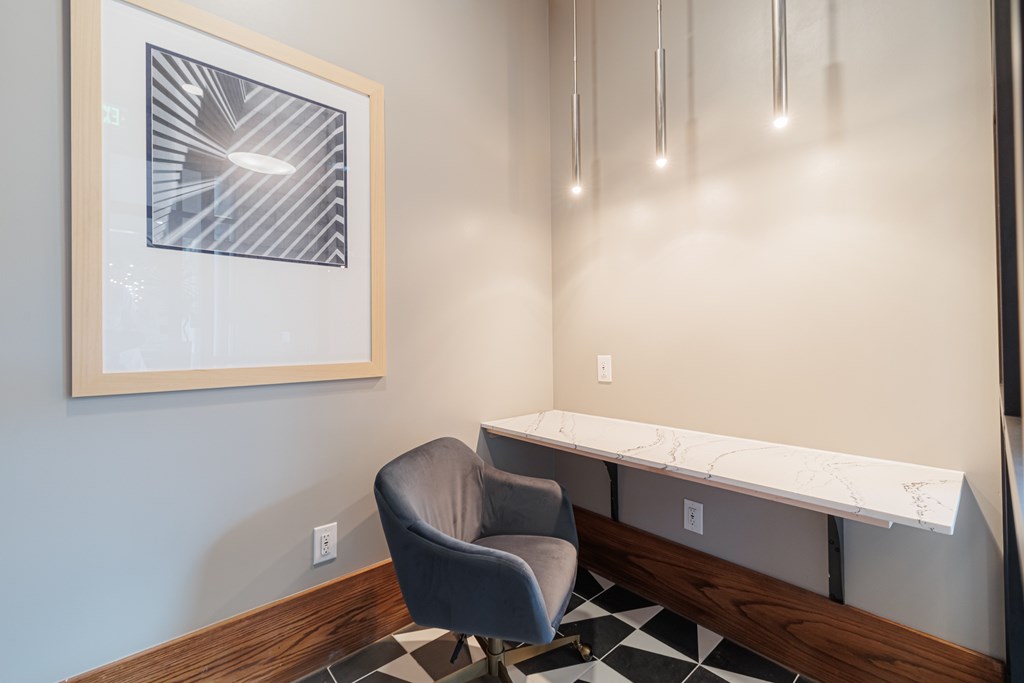 A black and white checkered floor with a black chair and a white marble table.