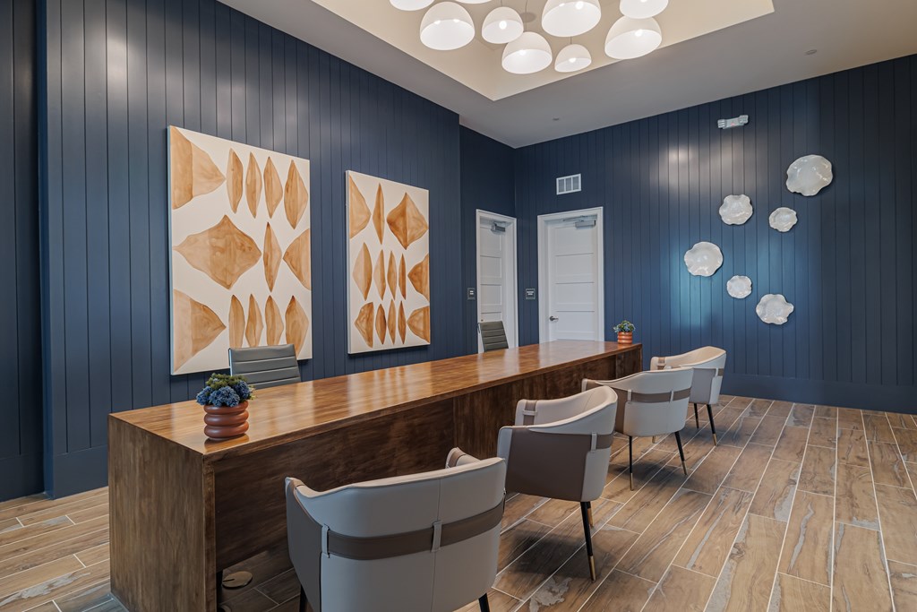 A reception area with a wooden desk and chairs.