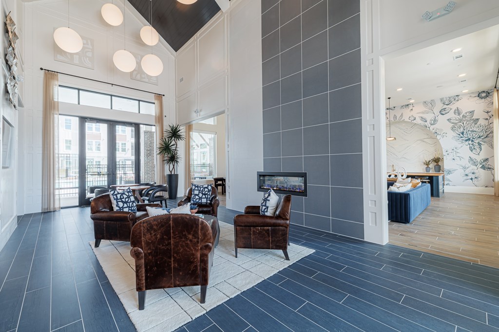 A living room with a dark brown sofa and a blue tiled floor.