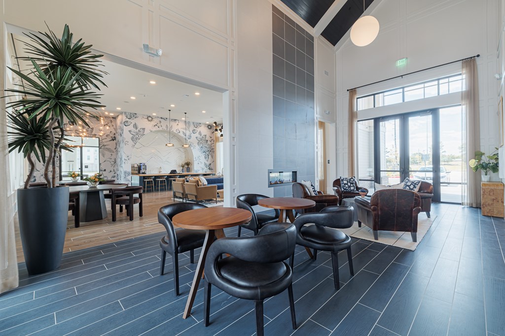 A large room with a long table and chairs.