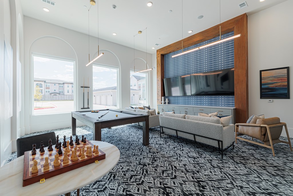 A living room with a chess board on the table.