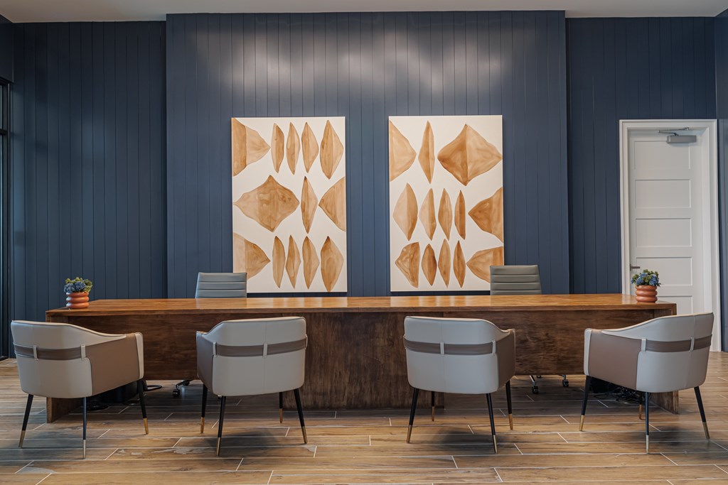 A conference room with a long table and chairs.