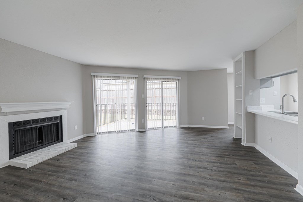 A spacious living room with a fireplace and sliding glass doors.