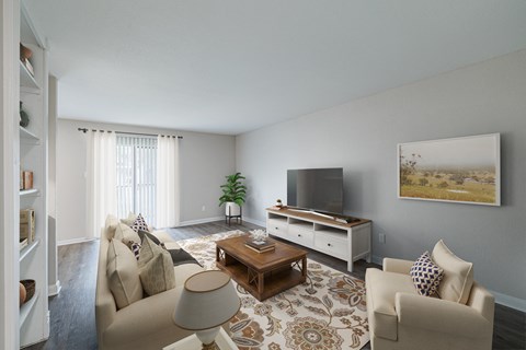 A living room with a couch, chair, and television.