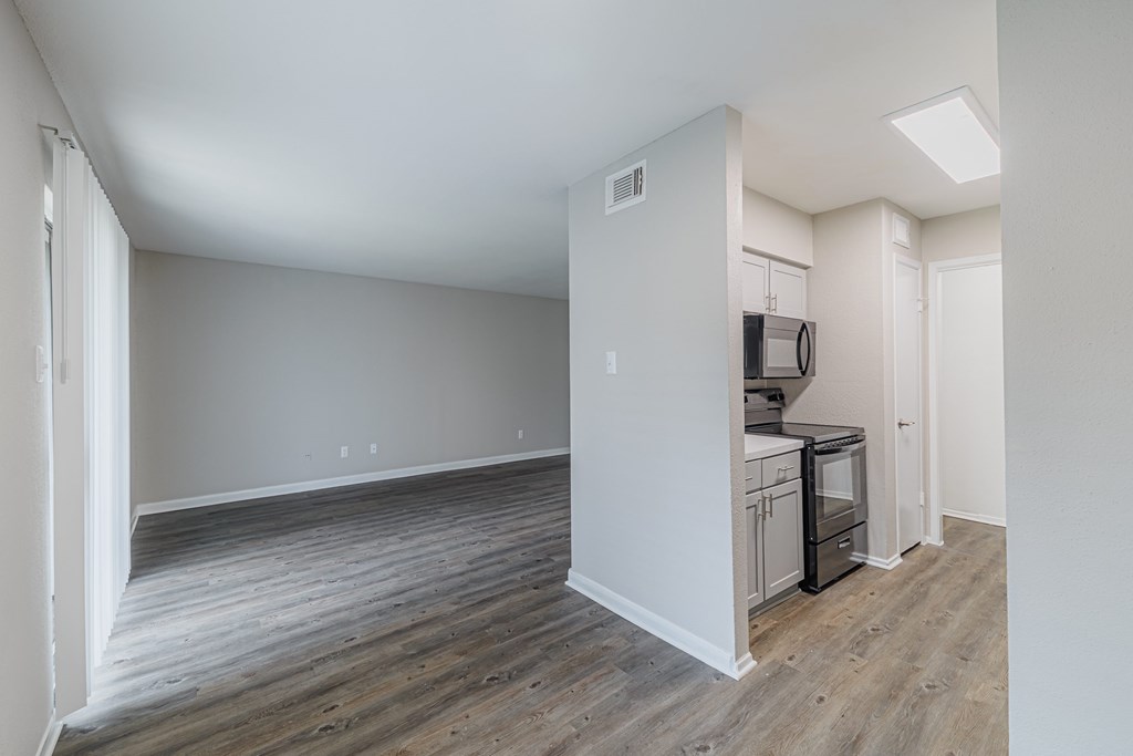 A kitchen area with a microwave and oven built into the cabinetry.