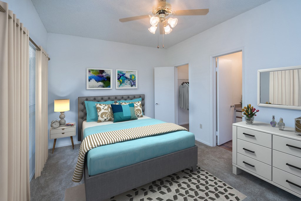 a bedroom with a bed and a ceiling fan