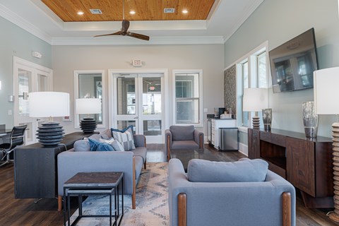 A living room with a grey couch and a wooden table.