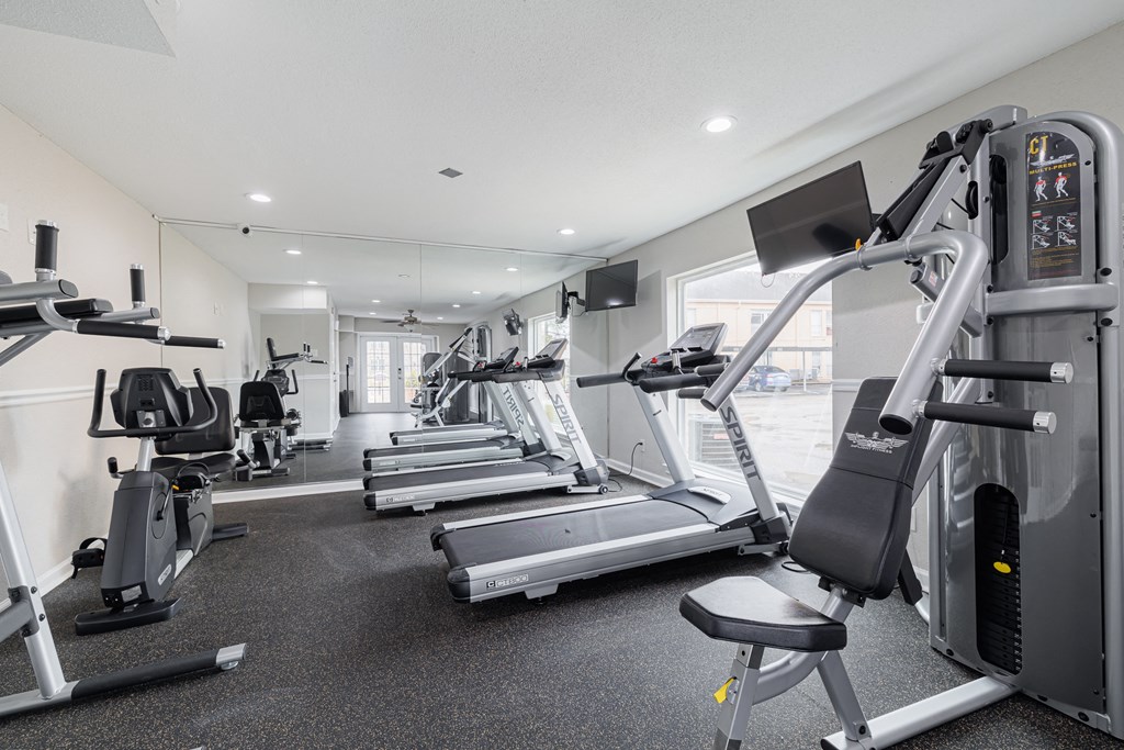 two treadmills and other exercise equipment in a gym