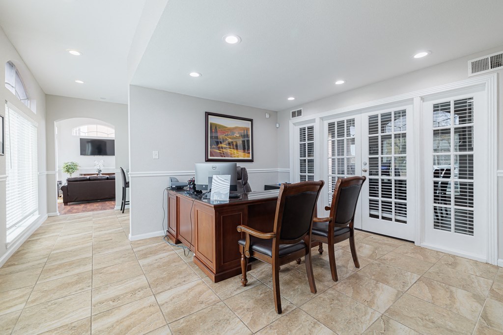 a home office with a desk and chairs