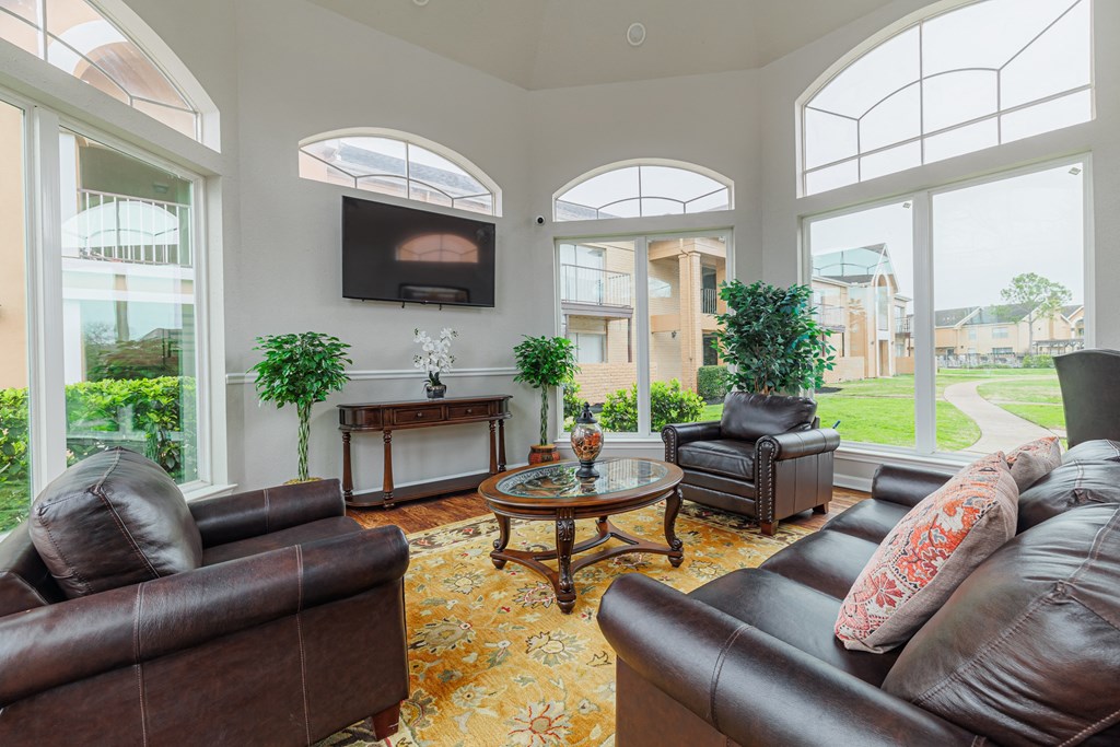 a living room with leather couches and a television