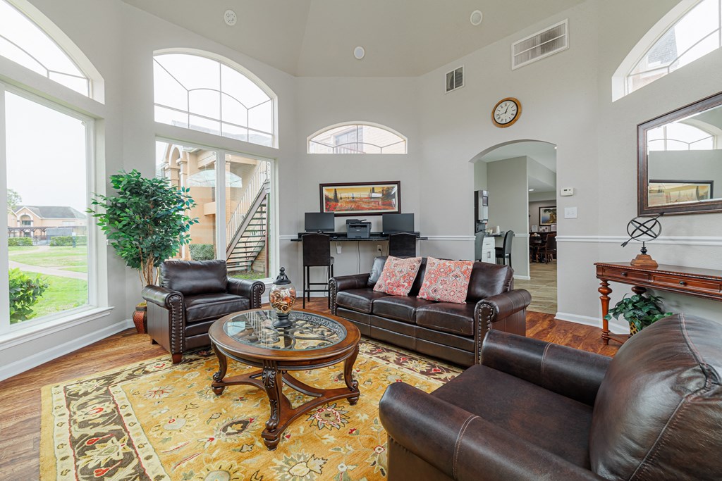 a living room with leather furniture and large windows