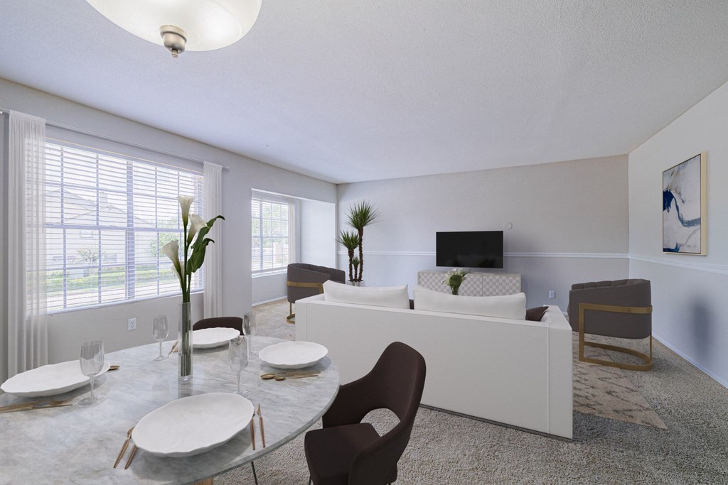 a living room with a white couch and a table and chairs