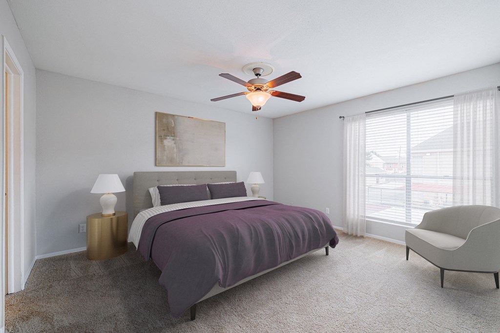 a bedroom with a bed and a ceiling fan