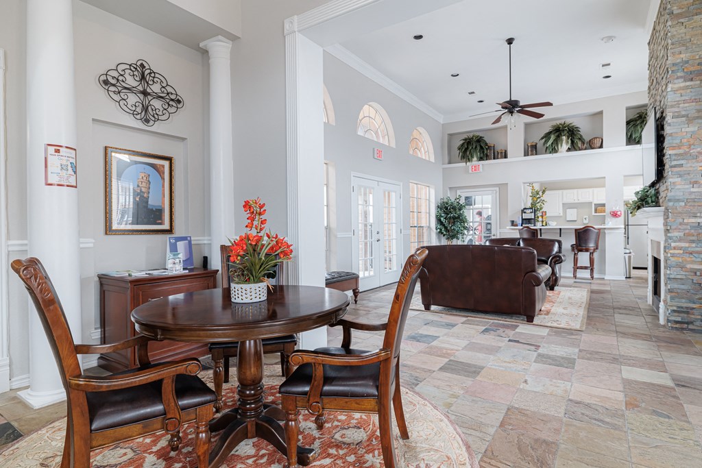a living room and dining room with a table and chairs