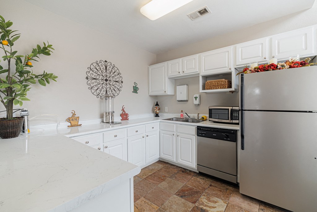 a kitchen with stainless steel appliances and white cabinets