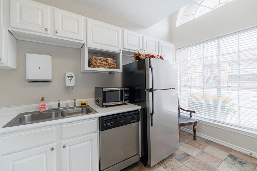a kitchen with stainless steel appliances and a sink and refrigerator