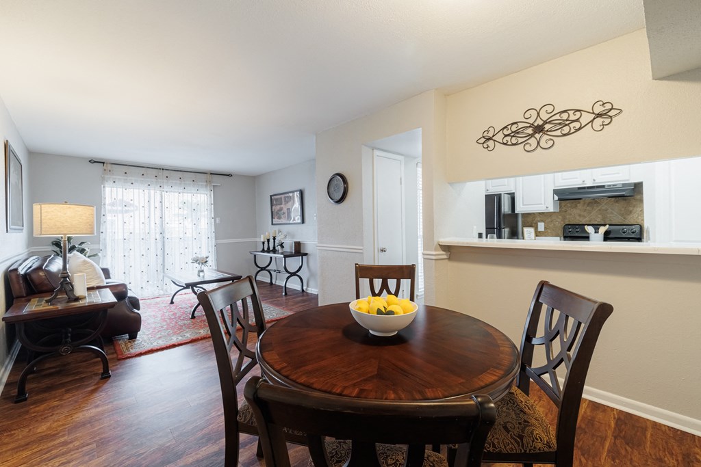 a dining room table with a bowl of fruit on it