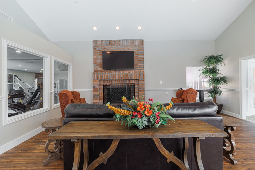a living room with a table and chairs and a fireplace