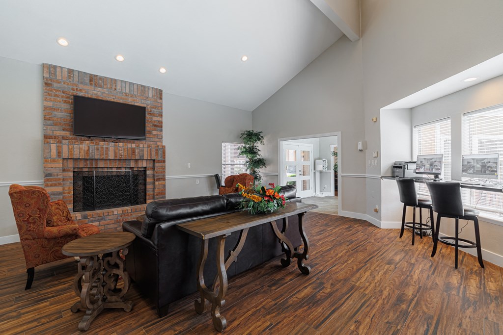 a living room with a fireplace and a table with chairs