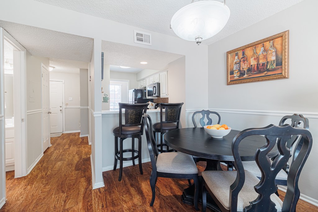A dining room with a table set for two.