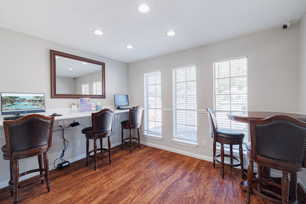 A room with wooden floors and a large mirror on the wall.