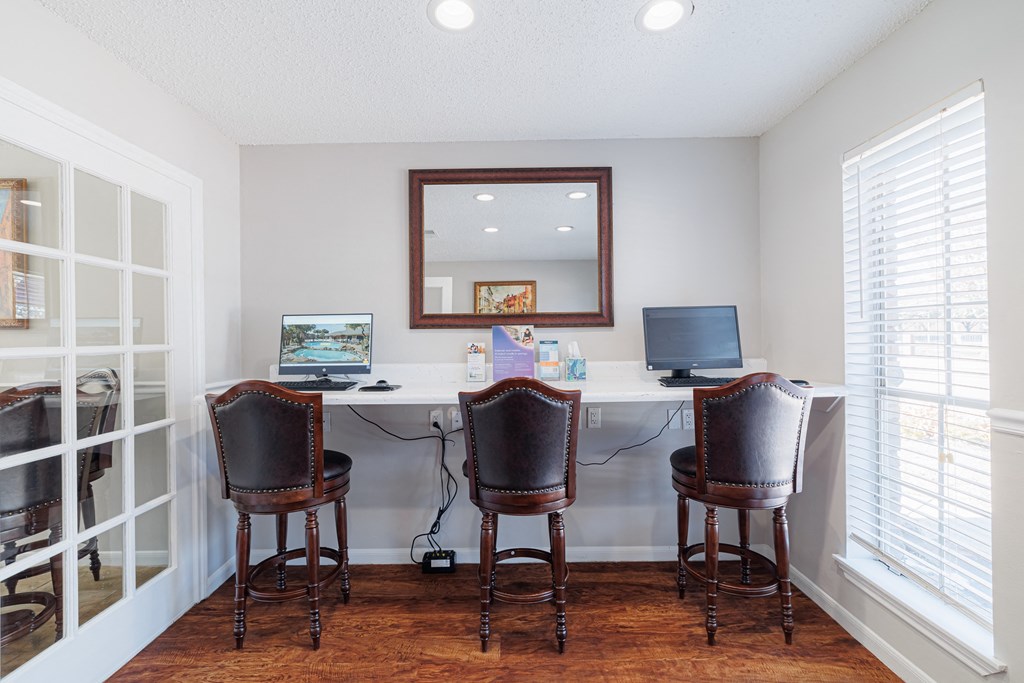 A room with a desk and two chairs.