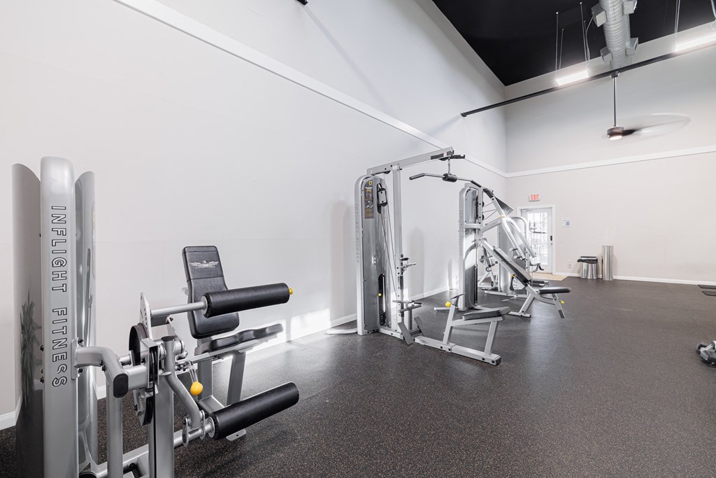 A gym with a variety of equipment including a leg press machine.