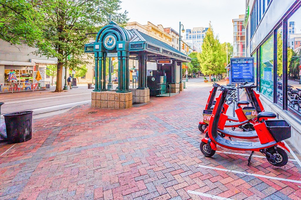 a red scooter parked in front of a store