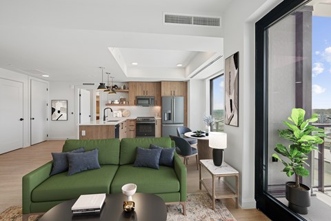 A modern living room with a green couch and a coffee table.