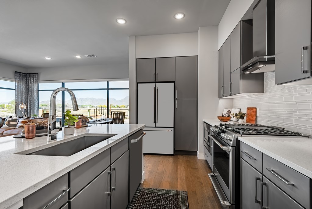 A modern kitchen with a large island and stainless steel appliances.
