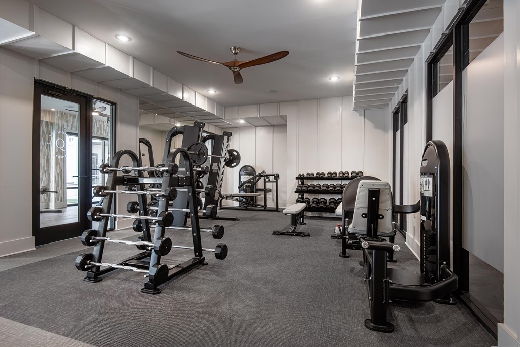A spacious home gym with a variety of equipment.