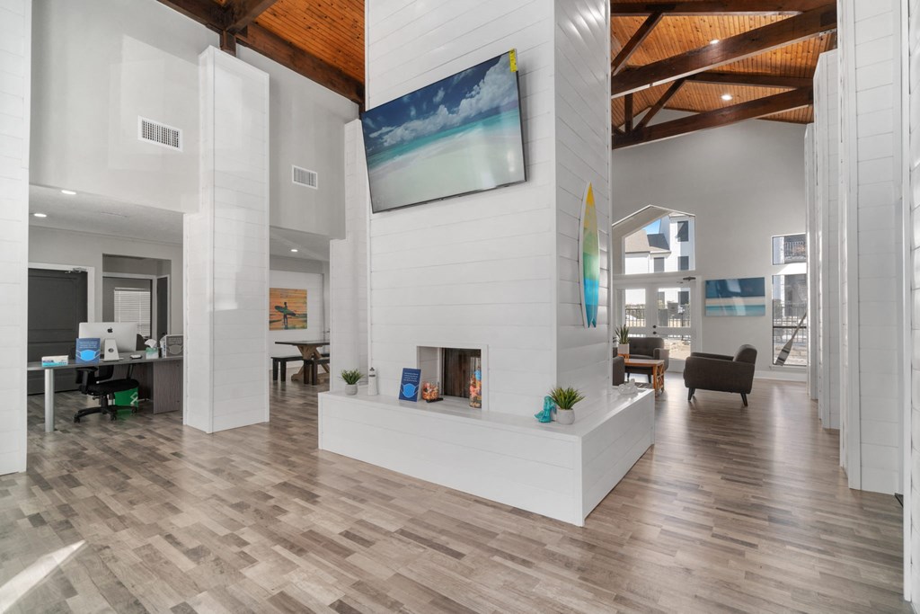 a living room with a fireplace and wooden floors