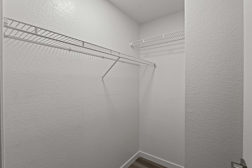 A white closet with a metal rack.