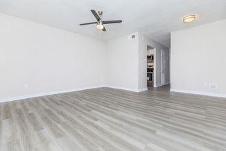 a living room with hardwood floors and white walls