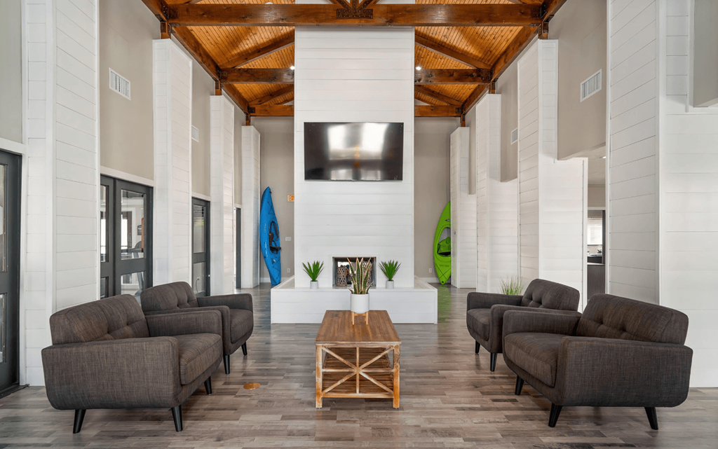 a lobby with couches and a table and a television